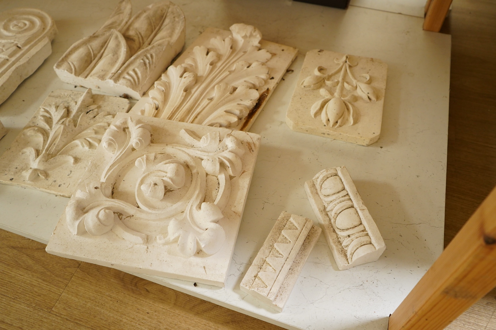 A collection of plaster-cast relief panels to include classical busts and foliage, largest 47cm high